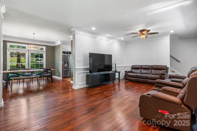 7648 Forest Oak Dr, Denver, NC 28037 - living room with crown molding, dark wood-type flooring, ceiling fan, wainscoting, and recessed lighting