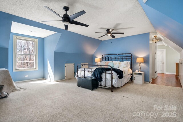 7648 Forest Oak Dr, Denver, NC 28037 - carpeted bedroom featuring vaulted ceiling, ceiling fan, and a textured ceiling