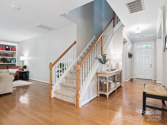 13930 Daltrey Ln, Charlotte, NC 28277 - entrance foyer featuring stairway, hardwood / wood-style floors, and crown molding