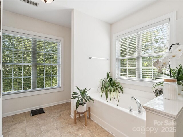 13930 Daltrey Ln, Charlotte, NC 28277 - bathroom featuring plenty of natural light, a bath, and tile patterned flooring