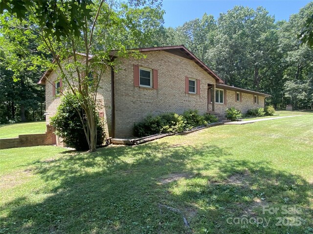 204 Biltmore Ave, China Grove, NC 28023 - view of home's exterior featuring brick siding and a yard