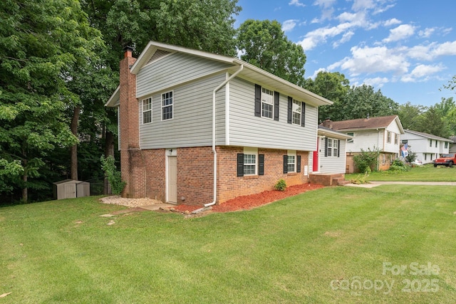 611 King Arthur Dr, Gastonia, NC 28056 - split level home featuring a chimney, a storage unit, a front yard, and brick siding