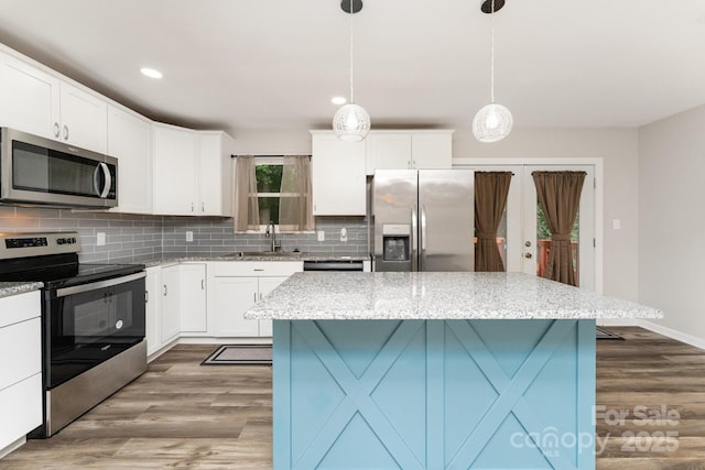 611 King Arthur Dr, Gastonia, NC 28056 - kitchen with appliances with stainless steel finishes, tasteful backsplash, wood finished floors, light stone countertops, and recessed lighting