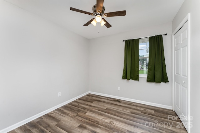 611 King Arthur Dr, Gastonia, NC 28056 - unfurnished bedroom with dark wood-style floors and a ceiling fan