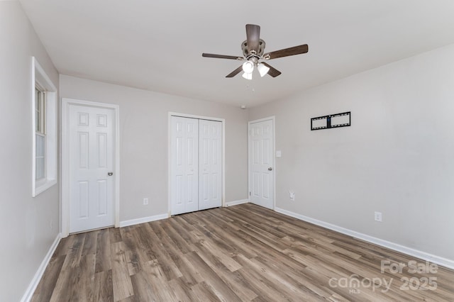 611 King Arthur Dr, Gastonia, NC 28056 - unfurnished bedroom with wood finished floors, a ceiling fan, and a closet