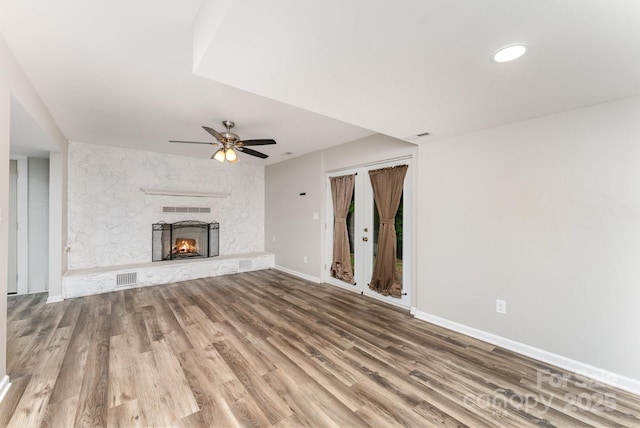 611 King Arthur Dr, Gastonia, NC 28056 - unfurnished living room featuring a ceiling fan, wood finished floors, and a fireplace