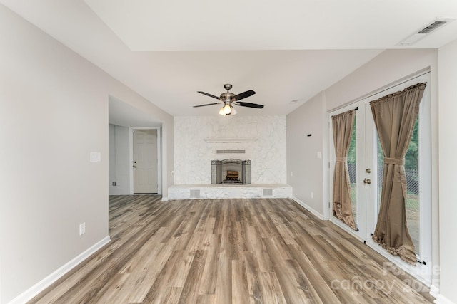 611 King Arthur Dr, Gastonia, NC 28056 - unfurnished living room featuring wood finished floors, ceiling fan, and a large fireplace