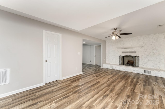 611 King Arthur Dr, Gastonia, NC 28056 - unfurnished living room with wood finished floors, a ceiling fan, and a fireplace
