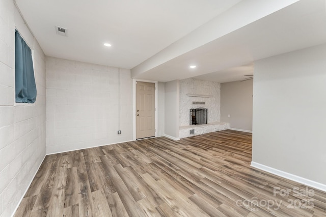 611 King Arthur Dr, Gastonia, NC 28056 - unfurnished living room featuring wood finished floors, a large fireplace, and recessed lighting