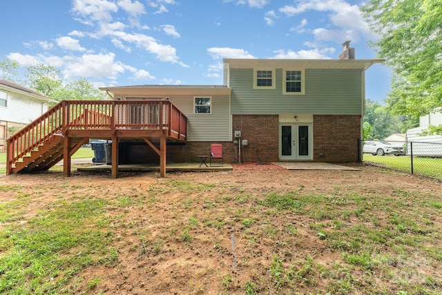 611 King Arthur Dr, Gastonia, NC 28056 - back of property with french doors, stairway, a wooden deck, a chimney, and brick siding