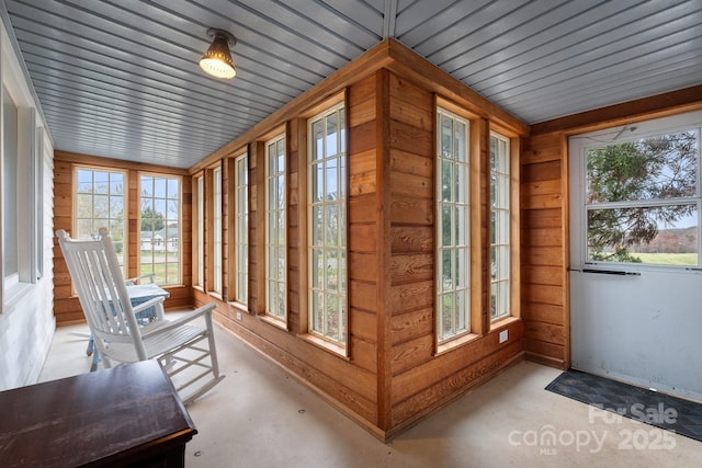 3809 Union Hill Rd, East Bend, NC 27018 - unfurnished sunroom featuring concrete flooring and wood walls