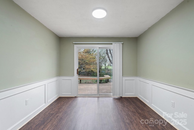 3809 Union Hill Rd, East Bend, NC 27018 - spare room with dark wood-type flooring, wainscoting, and a decorative wall