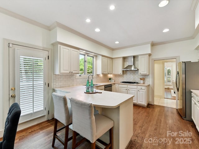 6546 Chestnut Grove Ln, Charlotte, NC 28210 - kitchen featuring freestanding refrigerator, wall chimney range hood, dishwashing machine, crown molding, and gas cooktop