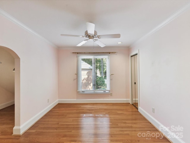 6546 Chestnut Grove Ln, Charlotte, NC 28210 - spare room with arched walkways, ornamental molding, light wood-style flooring, a ceiling fan, and recessed lighting