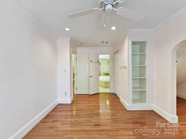6546 Chestnut Grove Ln, Charlotte, NC 28210 - spare room with arched walkways, light wood-style flooring, ornamental molding, ceiling fan, and built in shelves