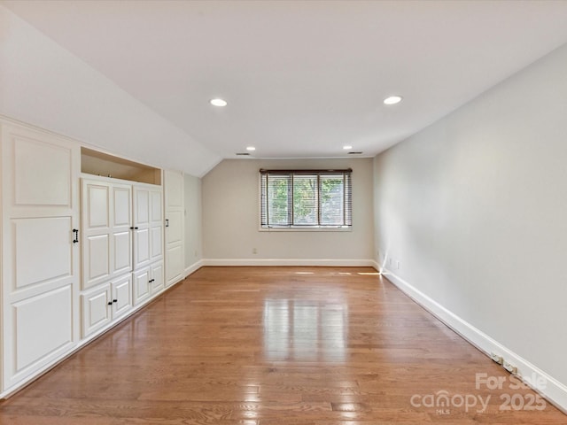 6546 Chestnut Grove Ln, Charlotte, NC 28210 - unfurnished bedroom featuring light wood-style floors, vaulted ceiling, and recessed lighting