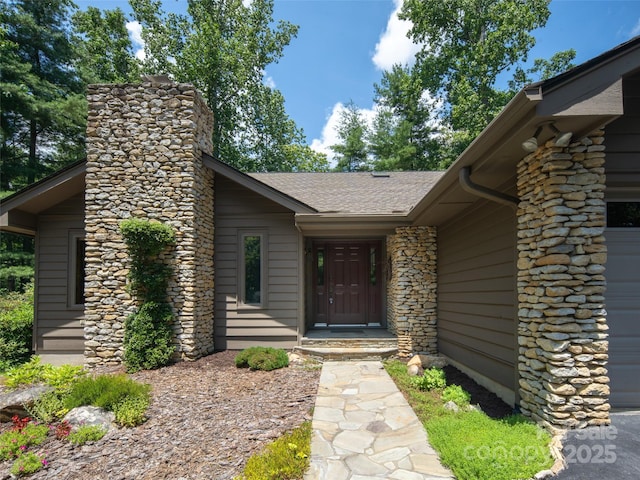 19 Jasmine Pl, Laurel Park, NC 28739 - view of exterior entry featuring a chimney and roof with shingles