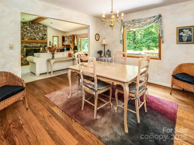 19 Jasmine Pl, Laurel Park, NC 28739 - dining area featuring wood finished floors, a chandelier, and a fireplace