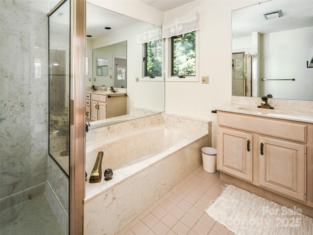 19 Jasmine Pl, Laurel Park, NC 28739 - full bathroom featuring a marble finish shower, tile patterned floors, a bath, and two vanities