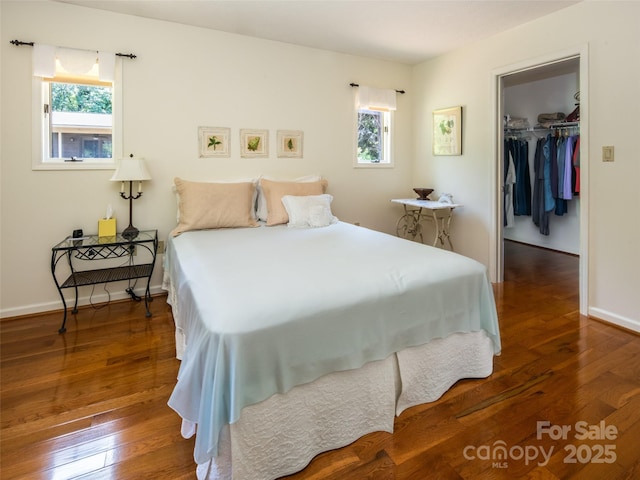 19 Jasmine Pl, Laurel Park, NC 28739 - bedroom featuring multiple windows, a walk in closet, hardwood / wood-style flooring, and a closet