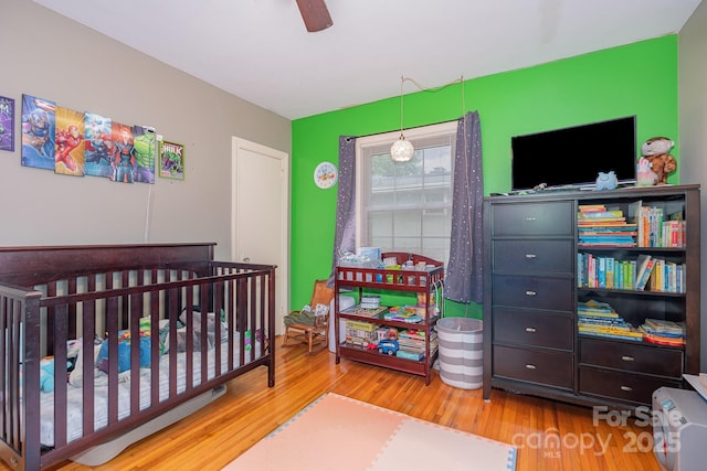 705 Townsend Ave, Gastonia, NC 28052 - bedroom featuring wood finished floors, ceiling fan, and a nursery area