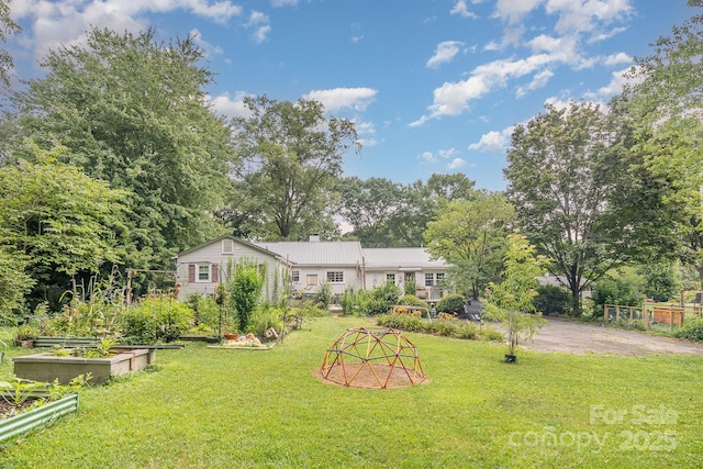 705 Townsend Ave, Gastonia, NC 28052 - rear view of house featuring a garden, a lawn, a chimney, and view of wooded area