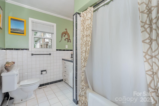 705 Townsend Ave, Gastonia, NC 28052 - bathroom with vanity, ornamental molding, tile walls, tile patterned floors, and shower / bath combo with shower curtain