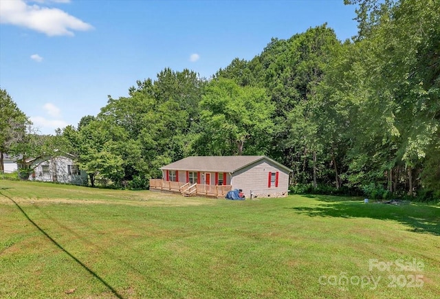 2611 Dallas Stanley Hwy, Stanley, NC 28164 - view of grassy yard with a deck and a view of trees