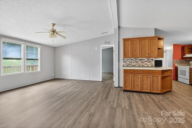2611 Dallas Stanley Hwy, Stanley, NC 28164 - kitchen with white range, open shelves, ceiling fan, light wood-style flooring, and a textured ceiling