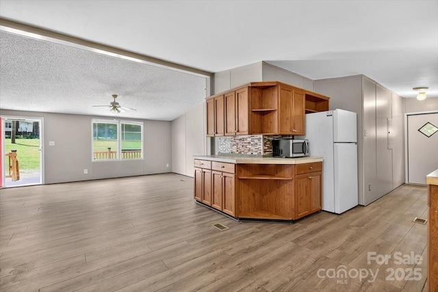 2611 Dallas Stanley Hwy, Stanley, NC 28164 - kitchen with open shelves, freestanding refrigerator, stainless steel microwave, and a ceiling fan