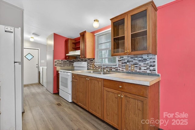2611 Dallas Stanley Hwy, Stanley, NC 28164 - kitchen featuring white appliances, under cabinet range hood, washer / dryer, tasteful backsplash, and light countertops