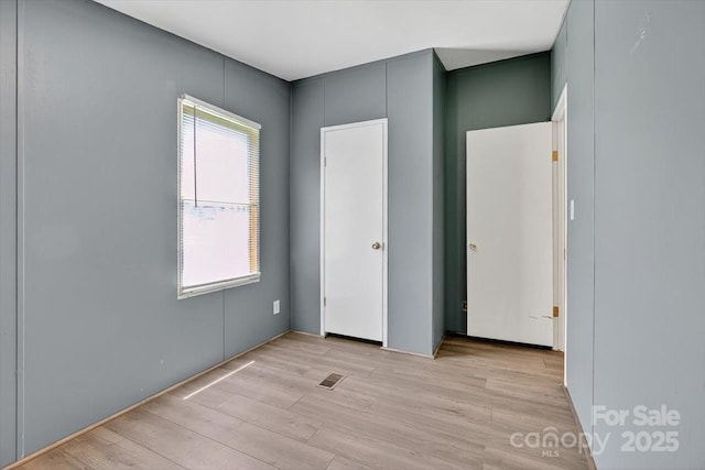 2611 Dallas Stanley Hwy, Stanley, NC 28164 - unfurnished bedroom with multiple windows and light wood finished floors