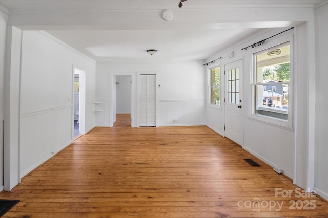 351 Dove Haven Ln, Hendersonville, NC 28791 - spare room featuring light wood-style floors, a wainscoted wall, and a smoke detector