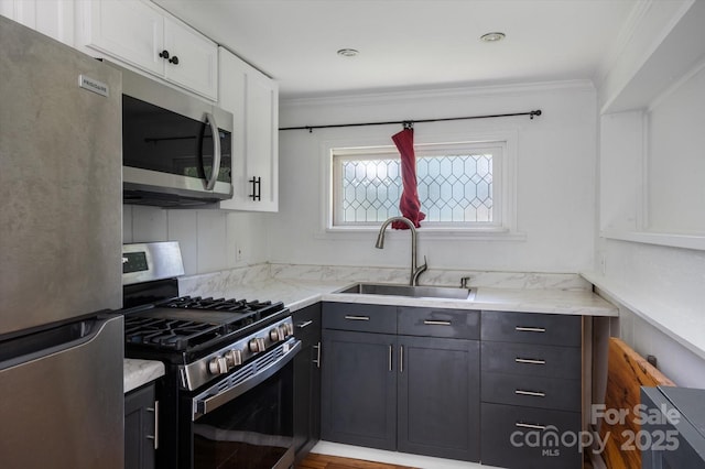 351 Dove Haven Ln, Hendersonville, NC 28791 - kitchen with stainless steel appliances, white cabinetry, light stone counters, and ornamental molding