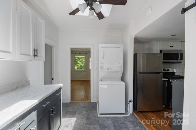 351 Dove Haven Ln, Hendersonville, NC 28791 - laundry area with stacked washing machine and dryer, a ceiling fan, and crown molding