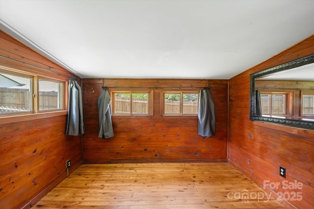 351 Dove Haven Ln, Hendersonville, NC 28791 - empty room with vaulted ceiling, wooden walls, and light wood-type flooring