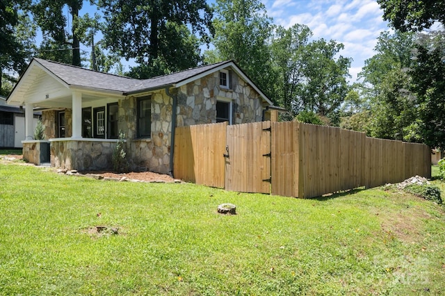 351 Dove Haven Ln, Hendersonville, NC 28791 - view of home's exterior featuring stone siding, a gate, a shingled roof, and a porch