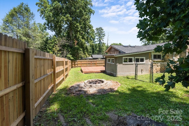351 Dove Haven Ln, Hendersonville, NC 28791 - fenced backyard with an outdoor fire pit and a wooden deck