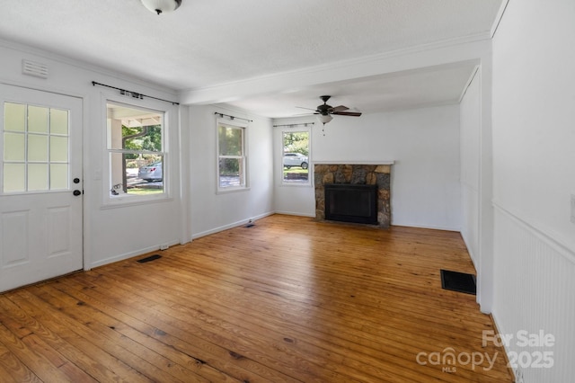 351 Dove Haven Ln, Hendersonville, NC 28791 - unfurnished living room with hardwood / wood-style floors, a fireplace, ceiling fan, and crown molding