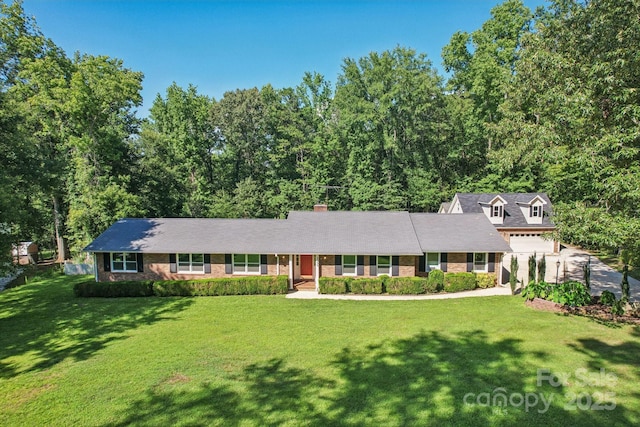 3333 Tanglewood Dr, Rock Hill, SC 29732 - view of front of home featuring a front lawn, brick siding, driveway, a chimney, and a garage