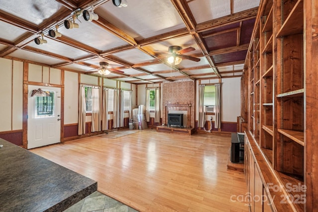3333 Tanglewood Dr, Rock Hill, SC 29732 - unfurnished living room featuring coffered ceiling, ceiling fan, a fireplace with raised hearth, plenty of natural light, and light wood-style floors