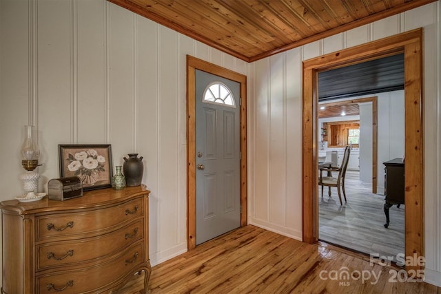 6939 Knob Ave, Connelly Springs, NC 28612 - foyer featuring light wood finished floors, a decorative wall, ornamental molding, and plenty of natural light