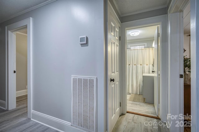 6939 Knob Ave, Connelly Springs, NC 28612 - hall featuring wood finished floors, ornamental molding, and a textured ceiling