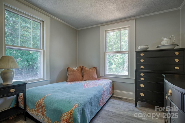 6939 Knob Ave, Connelly Springs, NC 28612 - bedroom featuring multiple windows, wood finished floors, a textured ceiling, and ornamental molding