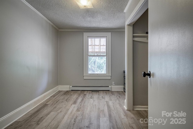 6939 Knob Ave, Connelly Springs, NC 28612 - unfurnished bedroom featuring wood finished floors, a textured ceiling, baseboard heating, and crown molding