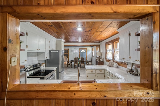 6939 Knob Ave, Connelly Springs, NC 28612 - kitchen with stainless steel appliances, wood ceiling, white cabinetry, light countertops, and a peninsula