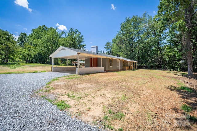 6939 Knob Ave, Connelly Springs, NC 28612 - view of front of property with gravel driveway, an attached carport, and a chimney