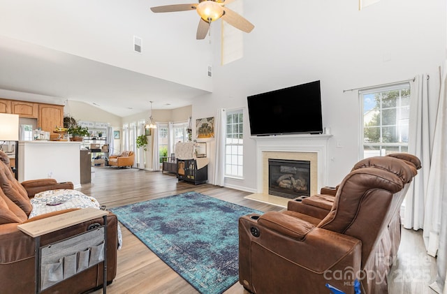 5128 Balsam Bark Ln, Fort Mill, SC 29708 - living room with plenty of natural light, ceiling fan, a fireplace with flush hearth, light wood-type flooring, and high vaulted ceiling