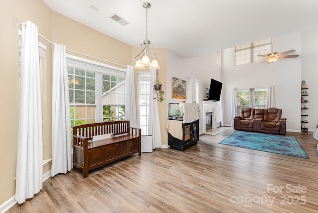 5128 Balsam Bark Ln, Fort Mill, SC 29708 - living area featuring light wood-style flooring, plenty of natural light, and a glass covered fireplace