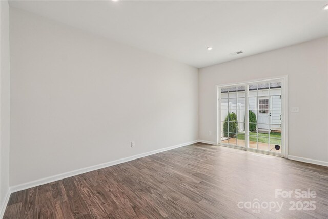 5037 Patton Dr, Gastonia, NC 28056 - empty room with dark wood-style floors and recessed lighting